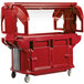 A red Cambro food cart with clear top.