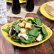 A Fiesta® luncheon plate with salad, meat, and croutons on it.