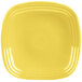 A yellow square Fiesta plate with a circular pattern in the center.