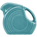 A teal Fiesta mini disc creamer pitcher with a handle.
