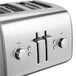 A close-up of a silver KitchenAid four slice toaster with four buttons.
