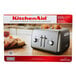 A KitchenAid Contour Silver toaster with toast inside.