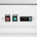 The white control panel with two electronic switches on an Avantco merchandiser refrigerator.