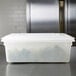 A white Rubbermaid polyethylene food storage box with a lid on a counter.