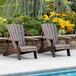 Two Lifetime Rustic Brown Adirondack chairs next to a pool.