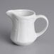 A Tuxton bright white china creamer pitcher with a handle.