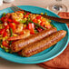 A plate of Warrington Farm Meats jerk chicken sausages with vegetables.