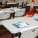 A white Lifetime professional-grade plastic folding table set with chairs.