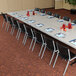 A long Lifetime professional-grade plastic folding table with chairs.