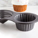 A Fox Run giant cupcake shaped pan with two holes.