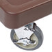 A dark brown and chrome dolly with wheels for a Cambro container.