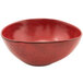 A red bowl with black specks.