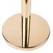 A gold metal pole with a round metal top on a white background.