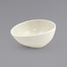 A white Front of the House porcelain ramekin with a small hole in it.
