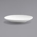 A white Front of the House Spiral porcelain plate with a small rim on a gray surface.