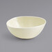 A Front of the House vanilla bean porcelain bowl with a small rim on a gray surface.