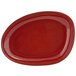 A red oval plate with a white border.
