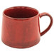 A red porcelain coffee mug with a handle.