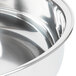 A close-up of a silver stainless steel pan with a handle.