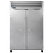 A Traulsen G Series reach-in freezer with two silver doors with metal handles.