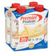 A group of Premier Protein Vanilla Protein Shake cartons with red bottle caps.
