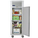 A white Traulsen G Series reach-in refrigerator with its door open and groceries inside.