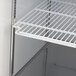 A white wire shelf in a Turbo Air glass door merchandising freezer.