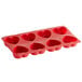 A red silicone heart mold with eight compartments.