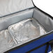 A blue Sterno insulated food carrier with silver foil inside.