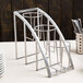 A Cal-Mil metal 3-cylinder vertical flatware holder on a table.