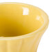A yellow china ramekin with a floral design.