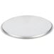 A Vollrath stainless steel domed pan cover on a round silver plate.