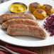A plate of Warrington Farm Meats knockwurst sausages with potatoes.