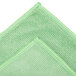 A green Unger SmartColor microfiber cloth with green edges.