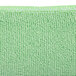 A close up of a green Unger SmartColor microfiber cloth.