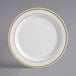 A white Visions plastic plate with gold trim.