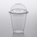 A Choice clear plastic cup with a PET dome lid on a table.