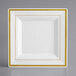 A white square plate with gold trim.