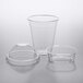 A group of Choice clear plastic cups with PET dome lids.