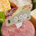 A Ketchum Manufacturing price tag with a number spear on a piece of meat.