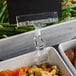 A Choice sign holder clipped to a tray of vegetables on a table.