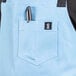 A blue Uncommon Chef canvas bib apron with black webbing and pockets.