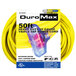 A yellow DuroMax 50' extension cord in a package with a plastic triple tap device.