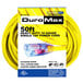 A yellow DuroMax extension power cord in a package.