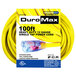 A yellow DuroMax 100' extension cable on a roll with blue and clear connectors.