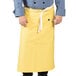 A person wearing a yellow Uncommon Chef Marvel Bistro apron.