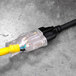 A yellow and black DuroMax extension cable with a yellow plug.
