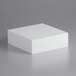 A white foam block on a grey surface.