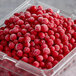 A plastic container of IQF red currants.