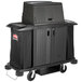 A black Rubbermaid housekeeping cart with a black locking cover over a large black container.